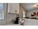 Breakfast bar with white cabinets and seating area with natural light at 2945 Monterey Dr, Decatur, GA 30032