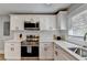 Bright kitchen with stainless appliances, white cabinets and marble countertops at 2945 Monterey Dr, Decatur, GA 30032
