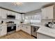 Spacious kitchen featuring stainless appliances, white cabinets and marble countertops at 2945 Monterey Dr, Decatur, GA 30032
