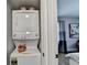 A stacked washer and dryer combo next to bedroom area at 2945 Monterey Dr, Decatur, GA 30032