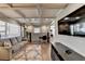 Spacious living room featuring coffered ceilings and hardwood floors, with a view to the kitchen at 2945 Monterey Dr, Decatur, GA 30032