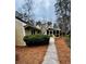 Exterior side view of a charming home with a walkway and a well-maintained garden at 4341 Kings Ne Way, Marietta, GA 30067