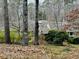 A beautiful suburban home, surrounded by tall trees, showcasing the serene beauty of the neighborhood at 4341 Kings Ne Way, Marietta, GA 30067