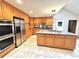 This kitchen has wood cabinets, stainless steel appliances, a tile backsplash, and granite countertops at 4341 Kings Ne Way, Marietta, GA 30067