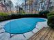 A pool with a winter safety cover that is surrounded by concrete and a short wood plank patio at 4341 Kings Ne Way, Marietta, GA 30067