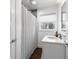 Bright bathroom featuring a shower curtain, hardwood floors, and lots of natural light at 1300 Valley Ct, Roswell, GA 30075