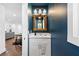 Elegant powder room with a vanity, ornate mirror, and contemporary lighting for a stylish touch at 1300 Valley Ct, Roswell, GA 30075