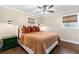 A well-lit bedroom with hardwood floors, a ceiling fan, and cozy decor at 1300 Valley Ct, Roswell, GA 30075