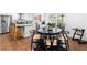 Dining space blending into a bright, modern kitchen with stainless steel appliances and ample counter space at 1300 Valley Ct, Roswell, GA 30075