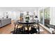 Stylish dining area with a round table, seating for six, and sliding doors to the outside, near the kitchen at 1300 Valley Ct, Roswell, GA 30075