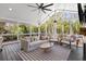Cozy sunroom with a ceiling fan, a striped rug, and views of the surrounding woods at 1300 Valley Ct, Roswell, GA 30075