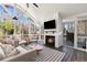 This beautiful sunroom has a fireplace, TV, and ample seating for relaxing and entertaining at 1300 Valley Ct, Roswell, GA 30075