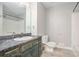 A bathroom featuring a single sink vanity, toilet, shower and tub combo at 1083 Lake Dr, Snellville, GA 30039