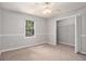 Bedroom with carpet flooring, a window, and closet with bi-fold doors at 1083 Lake Dr, Snellville, GA 30039