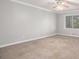 Bright bedroom with neutral walls, carpet, ceiling fan, and natural light at 1083 Lake Dr, Snellville, GA 30039