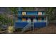 Two story blue home with a covered porch and matching banisters at 1083 Lake Dr, Snellville, GA 30039
