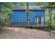 Rear view of the blue house featuring a large wooden deck at 1083 Lake Dr, Snellville, GA 30039