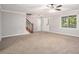 Open living room with neutral carpet, staircase and bright natural light at 1083 Lake Dr, Snellville, GA 30039