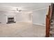 Spacious living room featuring a fireplace, neutral carpet, and staircase at 1083 Lake Dr, Snellville, GA 30039