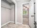Walk in closet with wire shelving and tile floors next to the bedroom at 1083 Lake Dr, Snellville, GA 30039