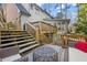 Multi-level deck features wood railings and multiple seating areas leading to the backyard at 160 Wing Mill Rd, Sandy Springs, GA 30350
