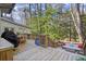 Large back deck features wood flooring, outdoor seating, and an entrance to the sunroom at 160 Wing Mill Rd, Sandy Springs, GA 30350