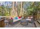 Cozy back deck featuring a wicker sofa set, and overlooking a backyard full of mature trees at 160 Wing Mill Rd, Sandy Springs, GA 30350