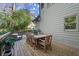 Spacious wooden deck with an outdoor dining area, a wicker sofa and chair overlooking the backyard at 160 Wing Mill Rd, Sandy Springs, GA 30350