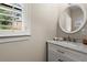 Bathroom featuring double sinks, vanity with marble countertop, and a large, round mirror at 160 Wing Mill Rd, Sandy Springs, GA 30350