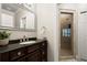 Bathroom with dark wood vanity, granite countertop, and walk-in shower with glass door at 160 Wing Mill Rd, Sandy Springs, GA 30350