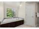 Inviting bathtub with a granite surround, and a large window with lots of natural light at 160 Wing Mill Rd, Sandy Springs, GA 30350