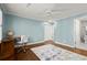 Bedroom with desk, ceiling fan, wood floors, and adjoining bathroom at 160 Wing Mill Rd, Sandy Springs, GA 30350