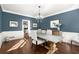 Dining room with hardwood floors, wainscoting, and stylish chandelier at 160 Wing Mill Rd, Sandy Springs, GA 30350