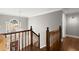 Foyer featuring wood staircase with decorative railing and a large window letting in natural light at 160 Wing Mill Rd, Sandy Springs, GA 30350
