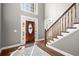 Grand foyer with hardwood floors and a staircase leading to the upper level at 160 Wing Mill Rd, Sandy Springs, GA 30350