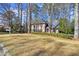 Charming two-story brick home with lush landscaping and a well-manicured lawn at 160 Wing Mill Rd, Sandy Springs, GA 30350