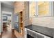 Kitchen with stainless steel appliances, brick oven surround and white cabinets with glass display at 160 Wing Mill Rd, Sandy Springs, GA 30350