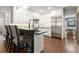 Modern kitchen featuring custom white cabinets, stainless steel appliances, and a breakfast bar with seating at 160 Wing Mill Rd, Sandy Springs, GA 30350