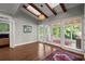 Light-filled living room with vaulted ceilings, wood beams and access to the backyard at 160 Wing Mill Rd, Sandy Springs, GA 30350