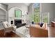 Spacious living room featuring a fireplace, large windows, and hardwood flooring at 160 Wing Mill Rd, Sandy Springs, GA 30350