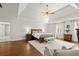 Bright main bedroom with a ceiling fan, hardwood floors, and a sitting area with a bench at 160 Wing Mill Rd, Sandy Springs, GA 30350