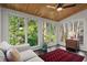Bright sunroom with wood ceiling, lots of windows, and an inviting sitting area at 160 Wing Mill Rd, Sandy Springs, GA 30350