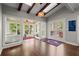 Bright sunroom with wood beams, multiple windows, and access to outdoor living spaces at 160 Wing Mill Rd, Sandy Springs, GA 30350