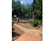 Community tennis court surrounded by lush greenery offers a great recreational amenity at 160 Wing Mill Rd, Sandy Springs, GA 30350