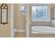 Bathroom showcasing an elegant soaking tub and a separate room with a toilet at 1811 Mcconnell Rd, Grayson, GA 30017
