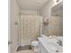 Neutral bathroom featuring a shower with patterned curtain, white vanity, and a large mirror at 1811 Mcconnell Rd, Grayson, GA 30017