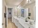 Bright bathroom featuring double sinks with a large mirror and modern fixtures at 1811 Mcconnell Rd, Grayson, GA 30017