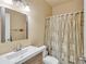 Neutral bathroom with modern vanity and shower with patterned curtain at 1811 Mcconnell Rd, Grayson, GA 30017