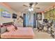 Vibrant bedroom featuring unique decor, a plush bed, and ceiling fan at 1811 Mcconnell Rd, Grayson, GA 30017