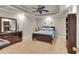 Relaxing bedroom showcasing tray ceiling, ceiling fan, and warm carpet flooring at 1811 Mcconnell Rd, Grayson, GA 30017